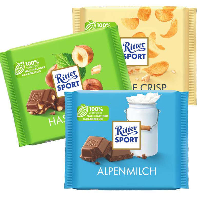 Zu sehen sind drei Packungen Schokolade der Marke "Rittersport"; unter anderem die Sorte "Alpenmilch", "Weiße Crisp" und "Haselnuss" je 100 Gramm.